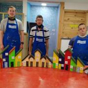 UCAN trainees make and paint new houses to be placed at woodland fairy village