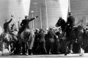 Police horses move in on pickets as coal lorries enter Ravenscraig, 1984