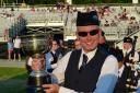 Winner Simon Gavin with the Grade 3 trophy at the World Pipe Band Championships