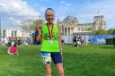Gina Little celebrates in Berlin after running her 600th marathon