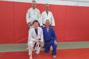 Charlie McLean (bottom left) is pictured alongside the other coaches at Irvine Judo Club