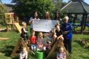 Tesco's Louise presents the cheque to Catrine Early Childhood Centre