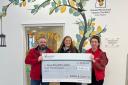 Colin and Hazel presenting the cheque to Ronald McDonald House from Ramsay & Jackson's 2022 charity run