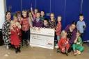 EGGER handed over a cheque for £300 to the Burns Bairns in Mauchline