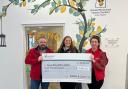 Colin and Hazel presenting the cheque to Ronald McDonald House from Ramsay & Jackson's 2022 charity run
