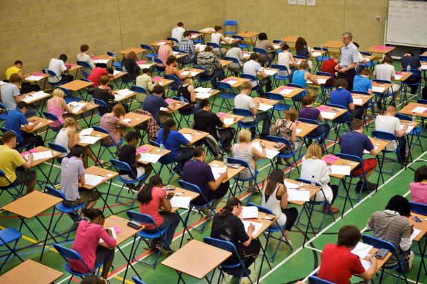 Students sitting an exam in an exam hall. Credit: PA