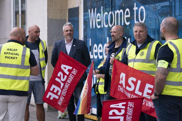 Protesters on the picket line outside a railway station (Danny Lawson/PA)