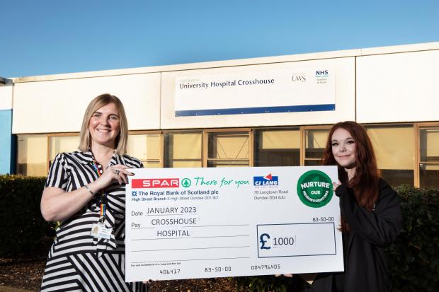 SPAR staff member Shannon Kenneth presents the cheque to Junior Doctor Yvonne Gormley