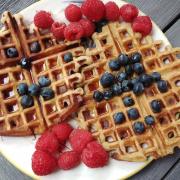 Waffles topped with fruit and syrup. Credit: Canva