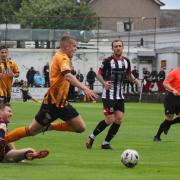 Ewan Thomson goes down under a challenge from Ross Lindsay during Talbot's 1-0 loss to Pollok on Saturday - but the visitors' penalty shouts were waved away