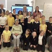 Primary 4 pupils with former teacher Mrs Jean McMurdo